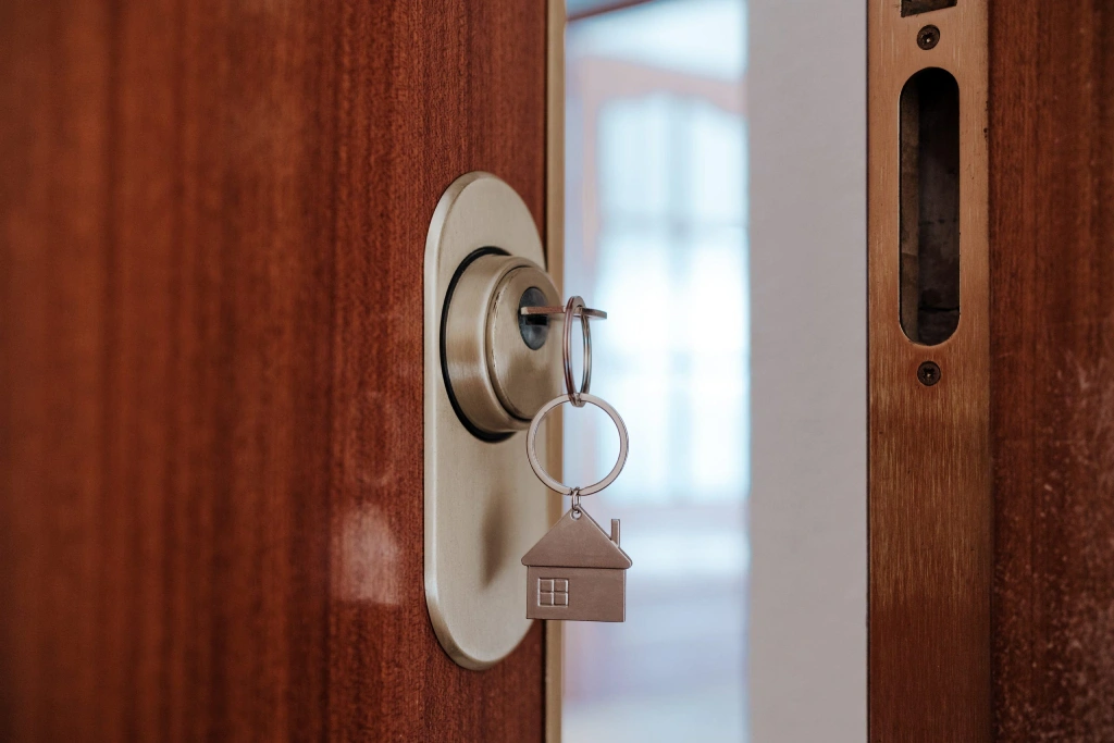 House key in a door lock, symbolizing home ownership or new beginnings.