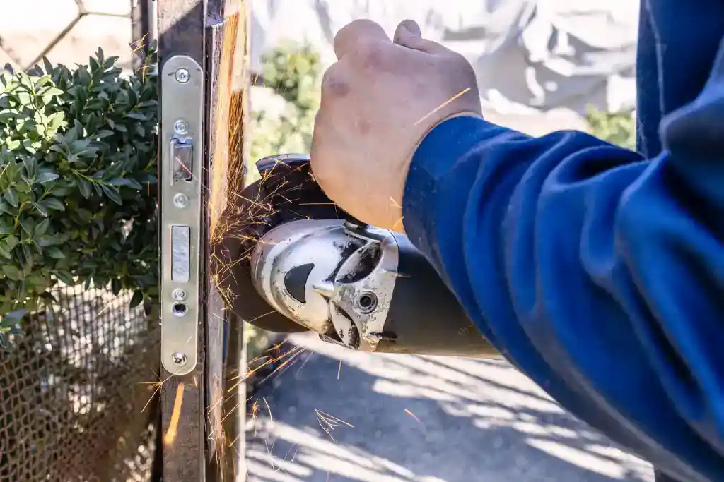 Close-up of a person using an angle grinder, creating sparks.