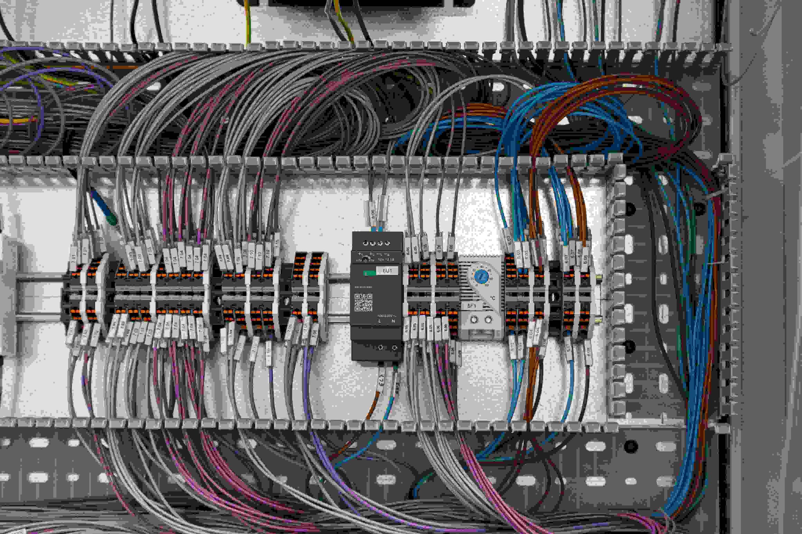 Close-up of an industrial electrical panel with many wires and components.