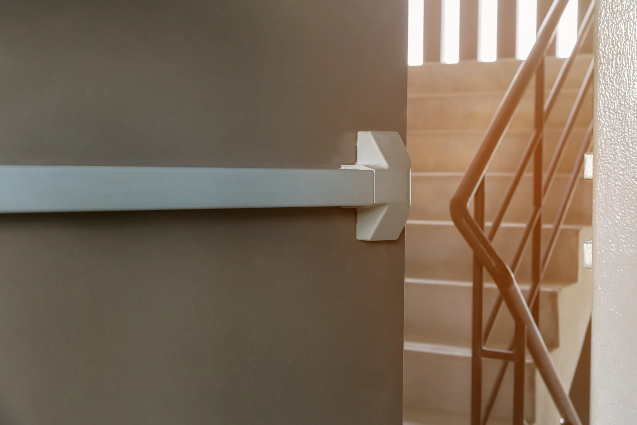 Emergency exit door with push bar and staircase