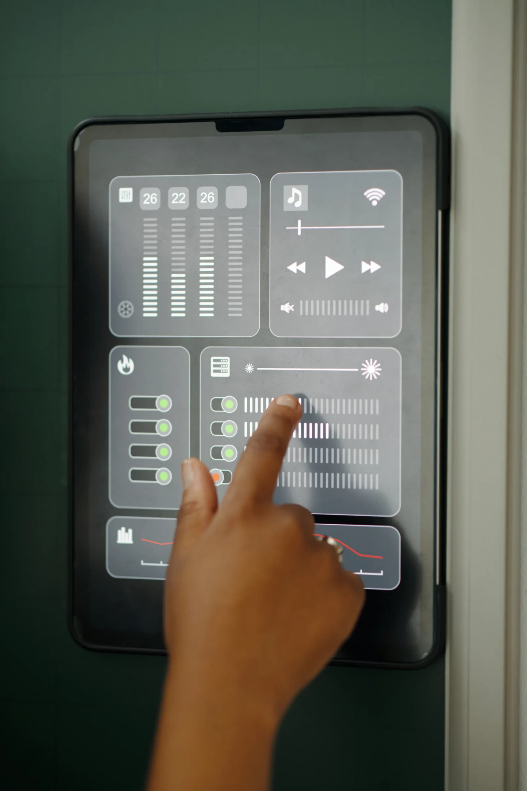 Hand interacting with a smart home control panel on a wall