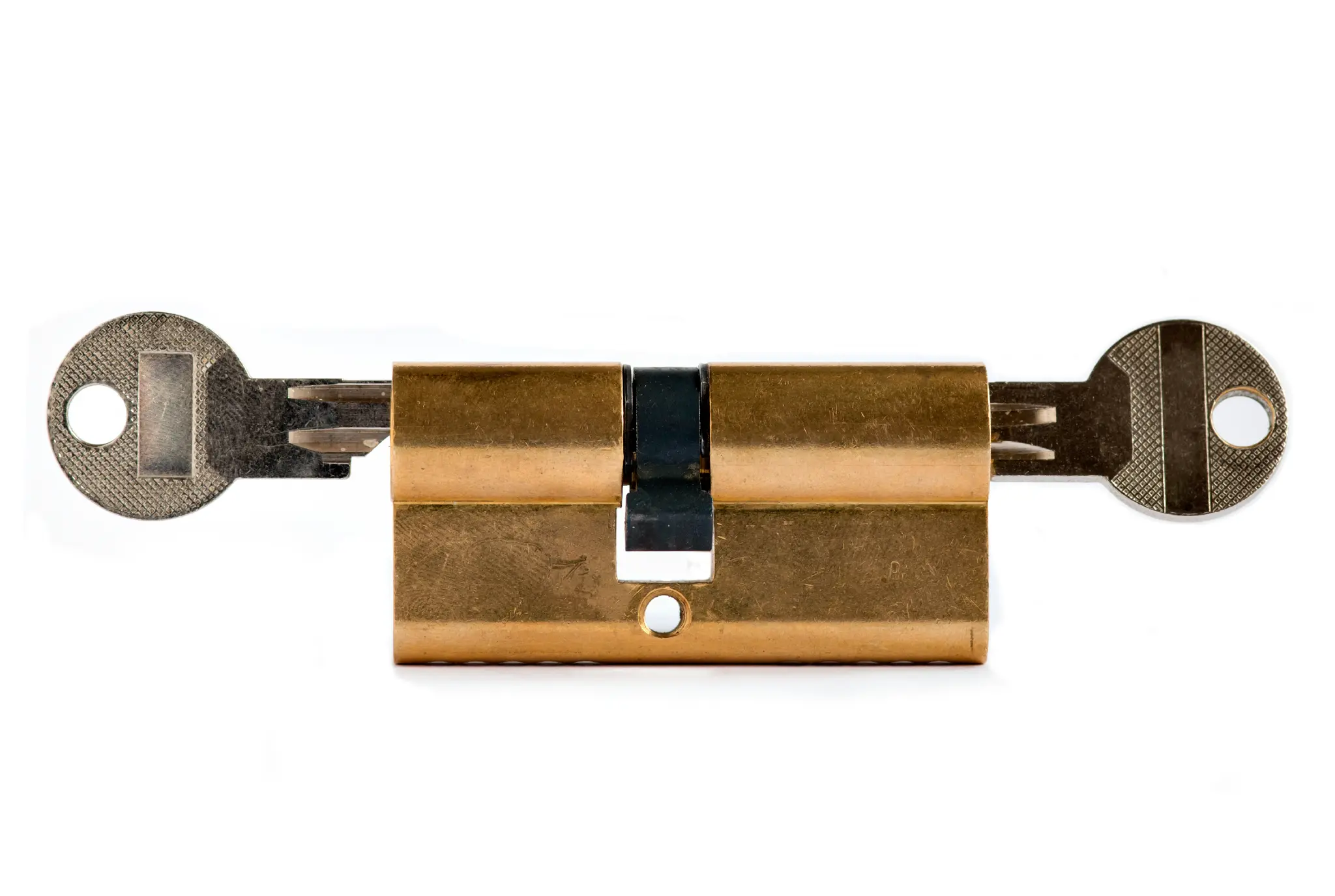 Two keys inserted into a brass lock cylinder on a white background.